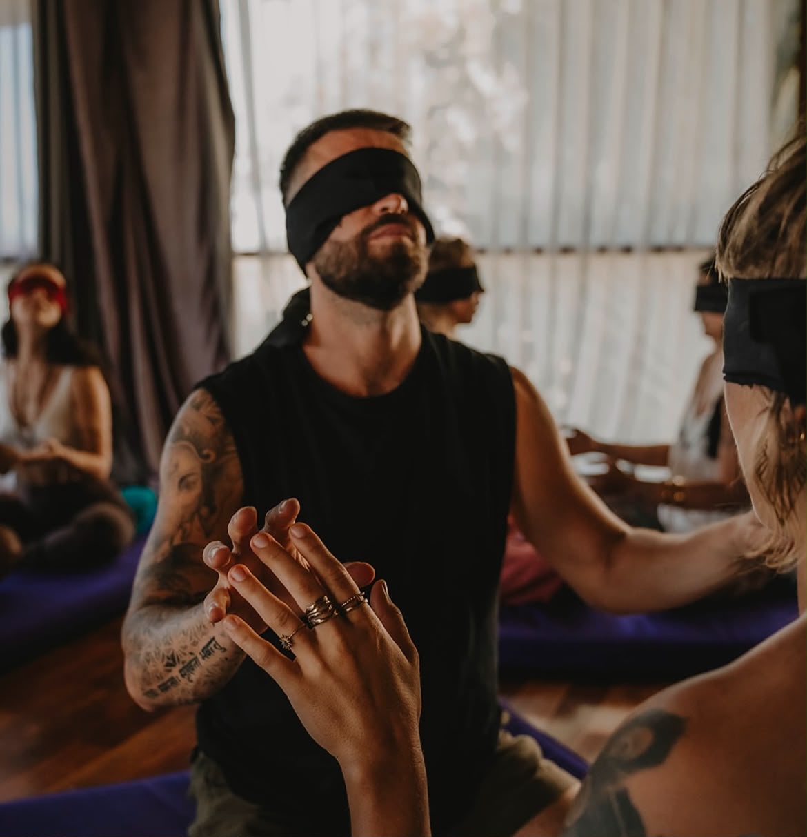 Blindfolded participants during a guided ceremony