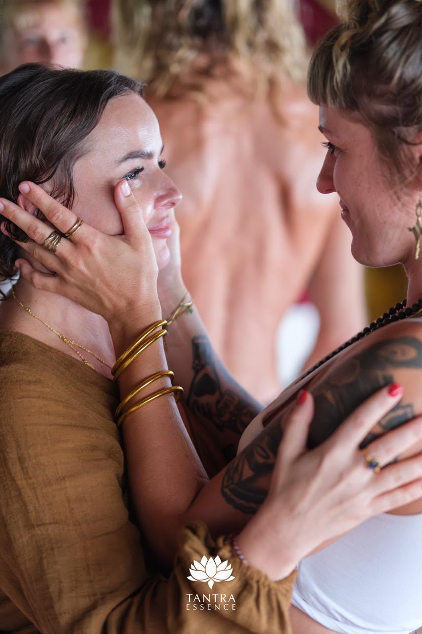 One participant tenderly holding another's face