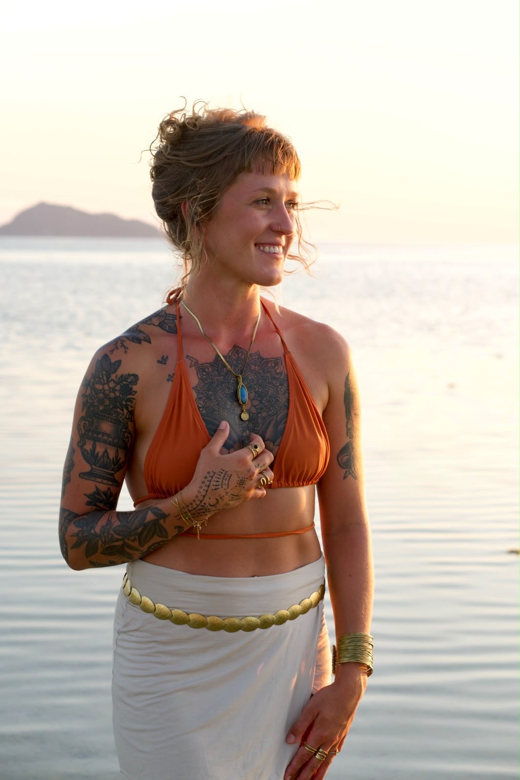 Pauli, founder of Araya, by the sea at sunset