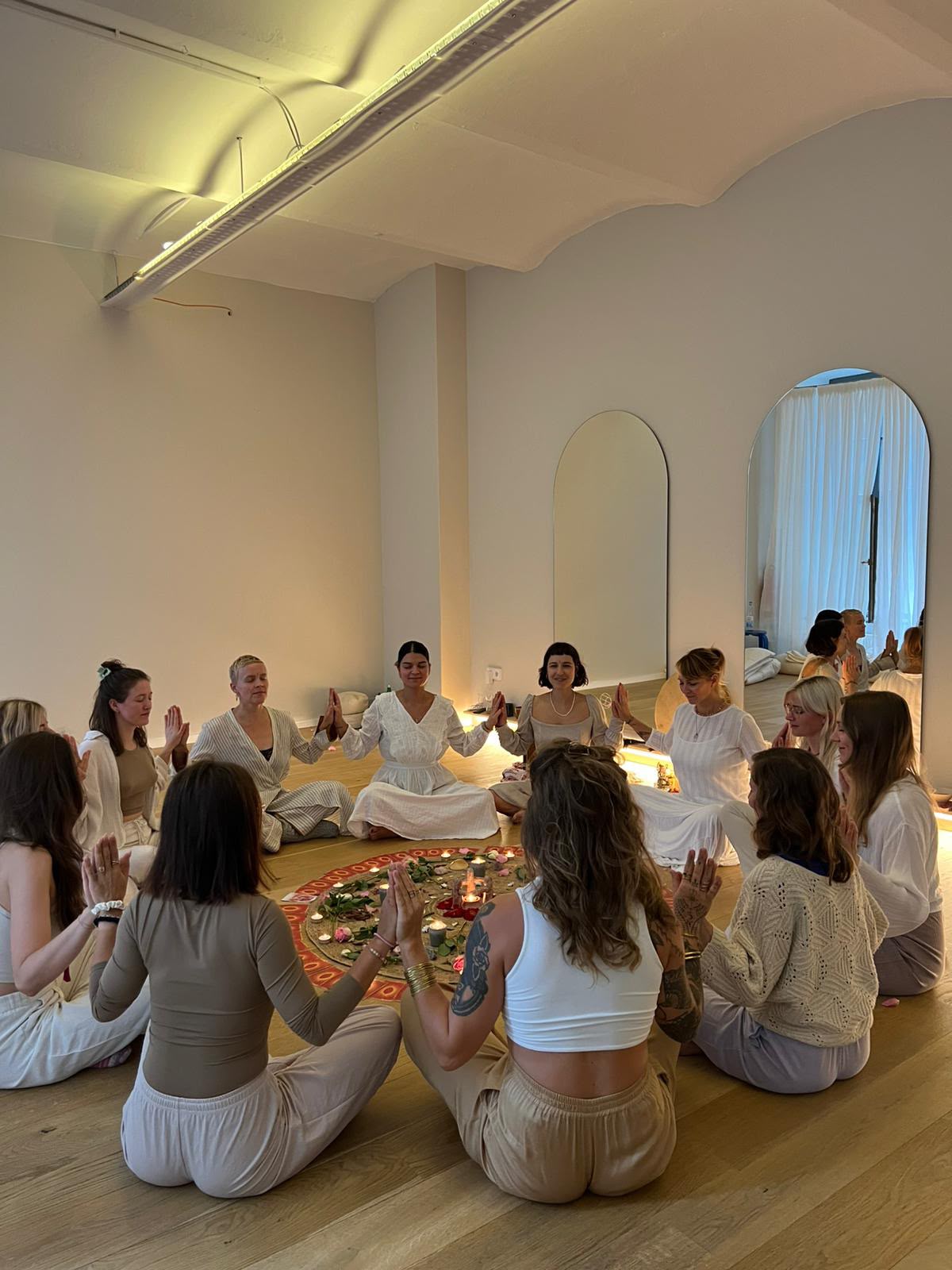 A women's circle by candlelight during a session